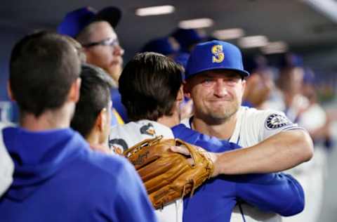 SEATTLE, WASHINGTON – OCTOBER 03: Kyle Seager #15 of the Seattle Mariners hugs teammates as he was pulled from the game during the ninth inning against the Los Angeles Angels at T-Mobile Park on October 03, 2021 in Seattle, Washington. (Photo by Steph Chambers/Getty Images)