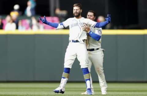 SEATTLE, WASHINGTON – APRIL 24: Ty France #23 celebrates with Jesse Winker #27 of the Seattle Mariners after Winker’s RBI single to score Adam Frazier #26 to beat the Kansas City Royals 5-4 during the twelfth inning at T-Mobile Park on April 24, 2022 in Seattle, Washington. (Photo by Steph Chambers/Getty Images)