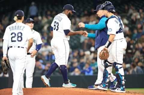 SEATTLE, WASHINGTON – MAY 09: Diego Castillo #63 of the Seattle Mariners hands over the game ball to manager Scott Servais #9 during the seventh inning against the Philadelphia Phillies at T-Mobile Park on May 09, 2022 in Seattle, Washington. (Photo by Abbie Parr/Getty Images)