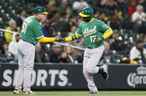 SEATTLE, WASHINGTON – MAY 24: Elvis Andrus #17 of the Oakland Athletics celebrates with third base coach Darren Bush #51 after hitting a home run during the sixth inning against the Seattle Mariners at T-Mobile Park on May 24, 2022 in Seattle, Washington. (Photo by Steph Chambers/Getty Images)