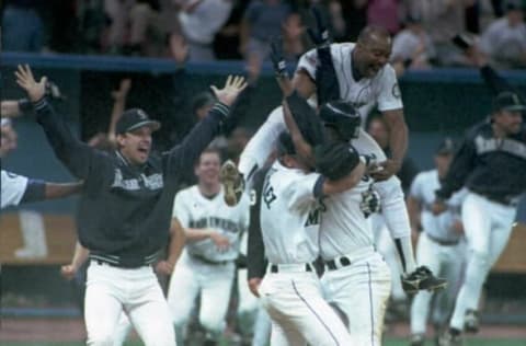 SEATTLE, WA – OCTOBER 9: Vince Coleman (top) and his Seattle Mariners teammates celebrate after Edgar Martinez’s (unidentified) game winning hit in the 11th inning of their 08 October playoff game against the New York Yankees in Seattle, WA. The Mariners won 6-5, to advance to the American League championship series. AFP PHOTO (Photo credit should read Michael Moore/AFP via Getty Images)