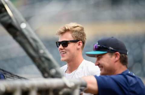 MINNEAPOLIS, MN – JUNE 13: Sam Carlson of Burnsville High School and second-round draft pick by the Seattle Mariners watches batting practice with manager Scott Servais.