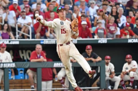 Omaha, NE – JUNE 27: Infielder Casey Martin #15 of the Arkansas Razorbacks makes a throw to first base in the fifth inning against the Oregon State Beavers during game two of the College World Series Championship Series on June 27, 2018 at TD Ameritrade Park in Omaha, Nebraska. (Photo by Peter Aiken/Getty Images)