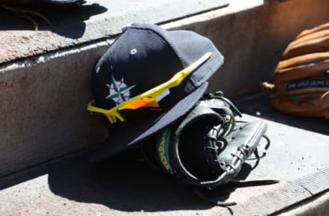 PEORIA, AZ – MARCH 4: A hat and glove of the Seattle Mariners are seen prior to the game against the San Diego Padres on March 4, 2015, at Peoria Stadium in Peoria, Arizona. The Mariners defeated the Padres 4-3 in 10 innings. (Photo by Rich Pilling/Getty Images)