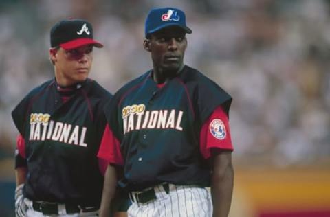 ATLANTA – JULY 10: National League All Stars Vladimir Guerrero and Chipper Jones look on during the MLB All-Star Game on July 10, 2000 at Turner Field in Atlanta, Georgia. (Photo by Jamie Squire/Getty Images)