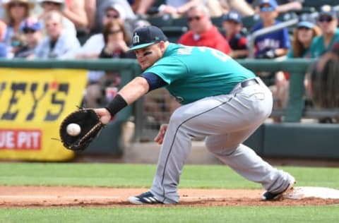 SURPRISE, AZ – MARCH 16: Daniel Vogelbach #20 of the Seattle Mariners catches a throw from teammate Jean Segura #2 for a force out at first base on a ground ball hit by Delino DeShields #3 of the Texas Rangers during the first inning of a spring training game at Surprise Stadium on March 16, 2018 in Surprise, Arizona. (Photo by Norm Hall/Getty Images)