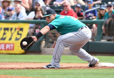 SURPRISE, AZ – MARCH 16: Daniel Vogelbach #20 of the Seattle Mariners catches a throw from teammate Jean Segura #2 for a force out at first base on a ground ball hit by Delino DeShields #3 of the Texas Rangers during the first inning of a spring training game at Surprise Stadium on March 16, 2018 in Surprise, Arizona. (Photo by Norm Hall/Getty Images)