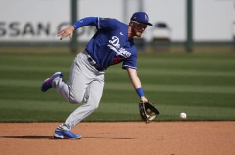 SURPRISE, ARIZONA – MARCH 07: Second baseman Michael Busch #58 of the Los Angeles Dodgers fields a ground ball against the Texas Rangers during the seventh inning of the MLB spring training baseball game at Surprise Stadium on March 07, 2021 in Surprise, Arizona. (Photo by Ralph Freso/Getty Images)