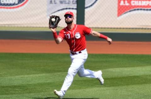 GOODYEAR, ARIZONA – MARCH 29: Jesse Winker #33 of the Cincinnati Reds catches a fly ball off the bat of Jake Fraley of the Seattle Mariners during the first inning of a spring training game at Goodyear Ballpark on March 29, 2021 in Goodyear, Arizona. (Photo by Norm Hall/Getty Images)