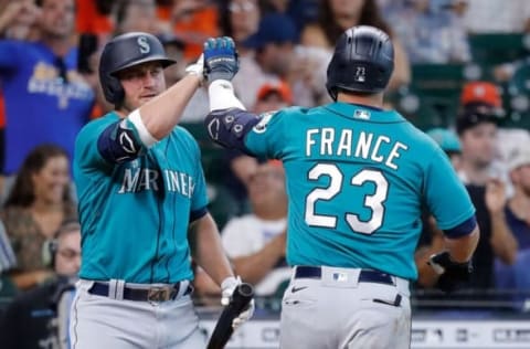 HOUSTON, TEXAS – AUGUST 22: Ty France #23 of the Seattle Mariners high fives Kyle Seager after hitting a home run in the ninth inning against the Houston Astros at Minute Maid Park on August 22, 2021 in Houston, Texas. (Photo by Bob Levey/Getty Images)