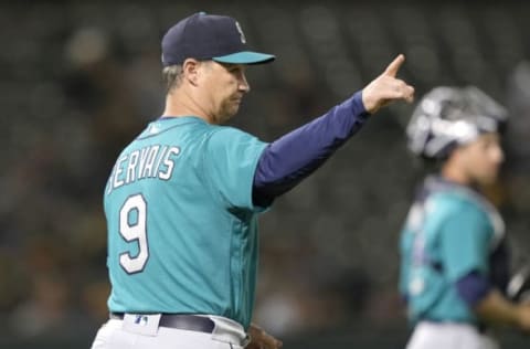 OAKLAND, CALIFORNIA – SEPTEMBER 20: Manager Scott Servais #9 of the Seattle Mariners signals the bullpen to make a pitching change against the Oakland Athletics in the bottom of the eighth inning at RingCentral Coliseum on September 20, 2021 in Oakland, California. (Photo by Thearon W. Henderson/Getty Images)