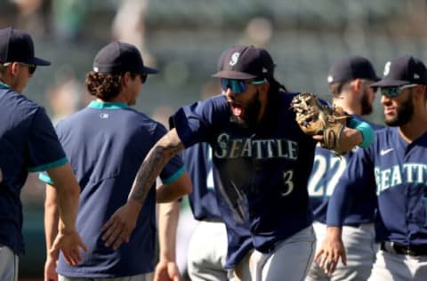 OAKLAND, CALIFORNIA – SEPTEMBER 23: J.P. Crawford #3 of the Seattle Mariners high-fives with teammates after they beat the Oakland Athletics at RingCentral Coliseum on September 23, 2021 in Oakland, California. (Photo by Ezra Shaw/Getty Images)