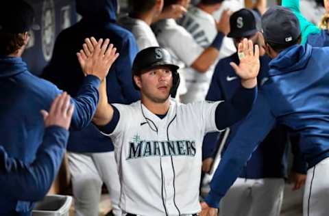 SEATTLE, WASHINGTON – SEPTEMBER 27: Ty France #23 of the Seattle Mariners celebrates with teammates after scoring in the third inning against the Oakland Athletics at T-Mobile Park on September 27, 2021 in Seattle, Washington. (Photo by Alika Jenner/Getty Images)