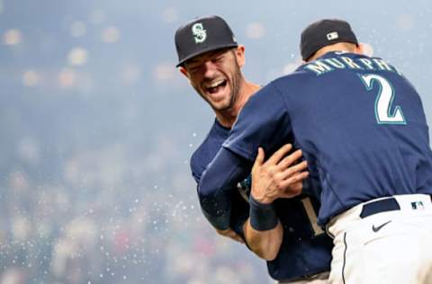 SEATTLE, WASHINGTON – OCTOBER 02: Mitch Haniger #17 and Tom Murphy #2 of the Seattle Mariners react after beating the Los Angeles Angels 6-4 at T-Mobile Park on October 02, 2021 in Seattle, Washington. (Photo by Steph Chambers/Getty Images)