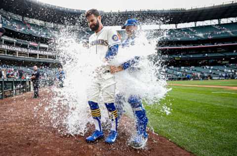 SEATTLE, WASHINGTON – APRIL 24: Jesse Winker #27 of the Seattle Mariners is doused with water after his RBI single to score Adam Frazier #26 to beat the Kansas City Royals 5-4 during the twelfth inning at T-Mobile Park on April 24, 2022 in Seattle, Washington. (Photo by Steph Chambers/Getty Images)