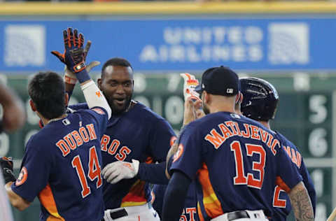 HOUSTON, TEXAS – JULY 31: Yordan Alvarez #44 of the Houston Astros receives a high five from Mauricio Dubon #14 after a walk-off single in the tenth inning against the Seattle Mariners at Minute Maid Park on July 31, 2022 in Houston, Texas. (Photo by Bob Levey/Getty Images)