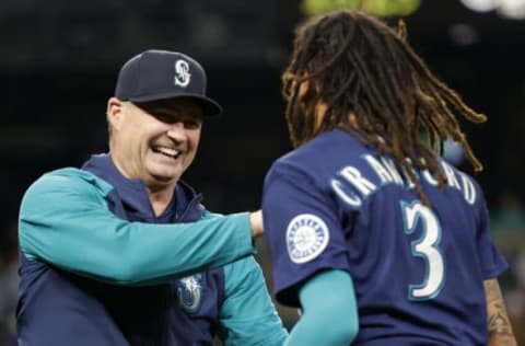 SEATTLE, WASHINGTON – SEPTEMBER 29: Manager Scott Servais #9 celebrates with J.P. Crawford #3 of the Seattle Mariners after his walk-off single during the eleventh inning to beat the Texas Rangers 10-9 at T-Mobile Park on September 29, 2022 in Seattle, Washington. (Photo by Steph Chambers/Getty Images)