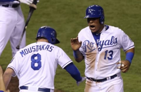 KANSAS CITY, MO – SEPTEMBER 16: Salvador Perez of the Kansas City Royals celebrates with Mike Moustakas after scoring. (Photo by Ed Zurga/Getty Images)