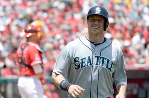 ANAHEIM, CA – JULY 20: Justin Smoak #17 of the Seattle Mariners smiles after his run in front of Hank Conger #24 of the Los Angeles Angels to take a 3-0 lead during the first inning at Angel Stadium of Anaheim on July 20, 2014 in Anaheim, California. (Photo by Harry How/Getty Images)