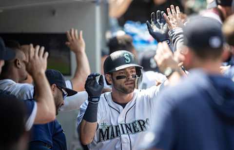 SEATTLE, WA – MAY 29: Mitch Haniger #17 of the Seattle Mariners is congratulated by teammates in the dugout after hitting a two-run home run off of starting pitcher Drew Smyly #33 of the Texas Rangers during the sixth inning of a game at T-Mobile Park on May 29, 2019 in Seattle, Washington. The Rangers won 8-7. (Photo by Stephen Brashear/Getty Images)