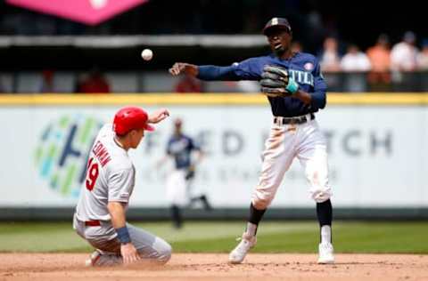 Jul 4, 2019; Seattle, WA, USA; Seattle Mariners second baseman Dee Gordon (9) turns a double play against St. Louis Cardinals second baseman Tommy Edman (19) during the fifth inning at T-Mobile Park. Mandatory Credit: Joe Nicholson-USA TODAY Sports