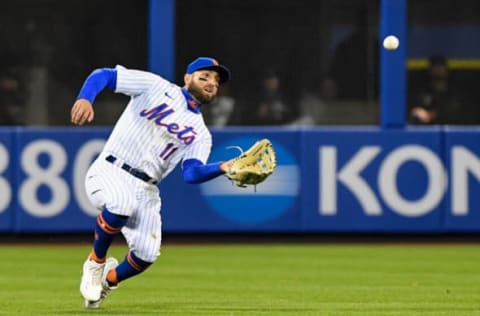 May 8, 2021; New York City, New York, USA; New York Mets center fielder Kevin Pillar (11) makes a sliding catch against the Arizona Diamondbacks in the fifth inning at Citi Field. Mandatory Credit: Dennis Schneidler-USA TODAY Sports