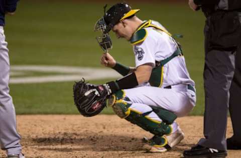 May 25, 2021; Oakland, California, USA; Oakland Athletics catcher Sean Murphy (12) reacts before a pitch against the Seattle Mariners. Mandatory Credit: John Hefti-USA TODAY Sports