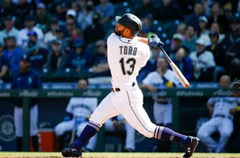 Sep 1, 2021; Seattle, Washington, USA; Seattle Mariners second baseman Abraham Toro (13) hits an RBI-sacrifice fly against the Houston Astros during the sixth inning at T-Mobile Park. Mandatory Credit: Joe Nicholson-USA TODAY Sports