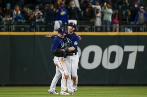 Oct 2, 2021; Seattle, Washington, USA; Seattle Mariners center fielder Jarred Kelenic (left) and right fielder Mitch Haniger (right) celebrate after defeating the Los Angeles Angels at T-Mobile Park. Mandatory Credit: Joe Nicholson-USA TODAY Sports