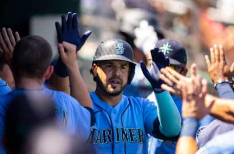 Apr 5, 2022; Goodyear, Arizona, USA; Seattle Mariners infielder Eugenio Suarez celebrates with teammates in the dugout after hitting a home run against the Cincinnati Reds during a spring training game at Goodyear Ballpark. Mandatory Credit: Mark J. Rebilas-USA TODAY Sports