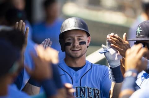 Apr 5, 2022; Goodyear, Arizona, USA; Seattle Mariners outfielder Jarred Kelenic celebrates with teammates in the dugout after hitting a home run against the Cincinnati Reds during a spring training game at Goodyear Ballpark. Mandatory Credit: Mark J. Rebilas-USA TODAY Sports