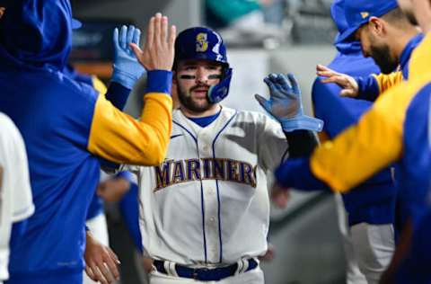 May 29, 2022; Seattle, Washington, USA; Seattle Mariners catcher Luis Torrens (22) celebrates in the dugout after scoring a run off a single hit by first baseman Ty France (23) (not pictured) during the sixth inning against the Houston Astros at T-Mobile Park. Mandatory Credit: Steven Bisig-USA TODAY Sports