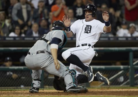 Apr 25, 2017; Detroit, MI, USA; Detroit Tigers catcher James McCann (34) slides in safe at home on Seattle Mariners catcher Mike Zunino (3) in the fifth inning at Comerica Park. Mandatory Credit: Rick Osentoski-USA TODAY Sports