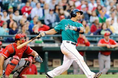 Jul 12, 2013; Seattle, WA, USA; Seattle Mariners left fielder Raul Ibanez (28) hits a solo home run against the Los Angeles Angels during the 4th inning at Safeco Field. Mandatory Credit: Steven Bisig-USA TODAY Sports