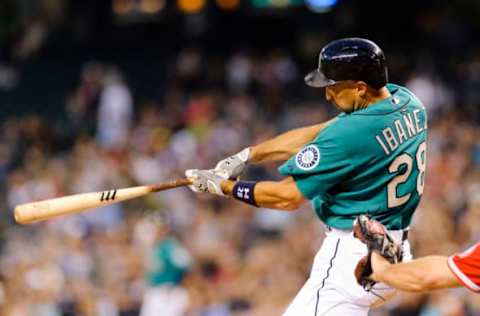 Jul 12, 2013; Seattle, WA, USA; Seattle Mariners left fielder Raul Ibanez (28) hits his second home run of the game against the Los Angeles Angels during the 7th inning at Safeco Field. Mandatory Credit: Steven Bisig-USA TODAY Sports