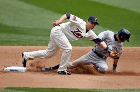 Jul 5, 2014; Minneapolis, MN, USA; New York Yankees right fielder Ichiro Suzuki (31) steals second base as Minnesota Twins second baseman Brian Dozier (2) applies the tag in the 5th inning at Target Field. The Twins win 2-1 in 11 innings. Mandatory Credit: Bruce Kluckhohn-USA TODAY Sports