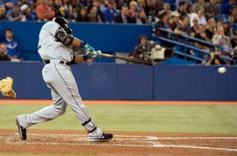 Sep 23, 2014; Toronto, Ontario, CAN; Seattle Mariners second baseman Robinson Cano (22) hits an RBI single during the third inning in a game against the Toronto Blue Jays at Rogers Centre. Mandatory Credit: Nick Turchiaro-USA TODAY Sports