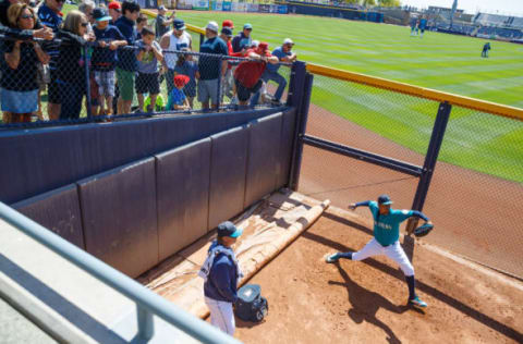 Mar 30, 2016; Peoria, AZ, USA; Fans look on as Seattle Mariners pitcher Felix Hernandez warms up in the bullpen prior to the game against the San Diego Padres during a spring training game at Peoria Sports Complex. Mandatory Credit: Mark J. Rebilas-USA TODAY Sports