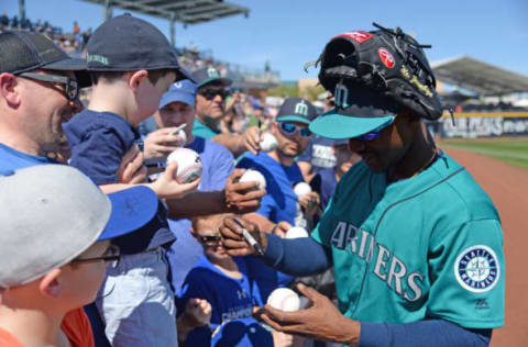 Mar 10, 2017; Peoria, AZ, USA; Seattle Mariners center fielder Jarrod Dyson (1) signs autographs before the first inning against the Chicago Cubs at Peoria Stadium. Mandatory Credit: Joe Camporeale-USA TODAY Sports