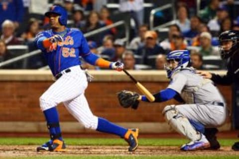 Oct 12, 2015; New York City, NY, USA; New York Mets center fielder Yoenis Cespedes (52) hits a three run home run during the fourth inning against the Los Angeles Dodgers in game three of the NLDS at Citi Field. Mandatory Credit: Andy Marlin-USA TODAY Sports