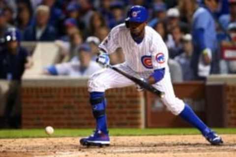 Oct 12, 2015; Chicago, IL, USA; Chicago Cubs center fielder Dexter Fowler (24) hits a sacrifice bunt during the sixth inning against the St. Louis Cardinals in game three of the NLDS at Wrigley Field. Mandatory Credit: Jerry Lai-USA TODAY Sports