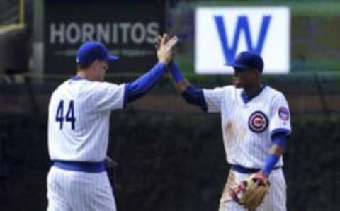 Jul 20, 2016; Chicago, IL, USA; Chicago Cubs first baseman Anthony Rizzo (44) and shortstop Addison Russell (27) celebrate their win against the New York Mets at Wrigley Field. The Cubs won 6-2. Mandatory Credit: David Banks-USA TODAY Sports