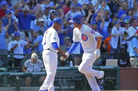 Aug 23, 2015; Chicago, IL, USA; Chicago Cubs third baseman Kris Bryant (17) is thanked for hitting a home run by third base coach Gary Jones (1) during the sixth inning against the Atlanta Braves at Wrigley Field. Mandatory Credit: Dennis Wierzbicki-USA TODAY Sports