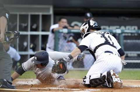 Jul 5, 2016; Chicago, IL, USA; New York Yankees right fielder Carlos Beltran (36) is tagged out by Chicago White Sox catcher Alex Avila (31) during the first inning at U.S. Cellular Field. Mandatory Credit: Caylor Arnold-USA TODAY Sports