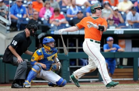 Jun 20, 2016; Omaha, NE, USA; Miami Hurricanes catcher Zack Collins (0) drives in a run in the eighth inning against the UC Santa Barbara Gauchos in the 2016 College World Series at TD Ameritrade Park. UC Santa Barbara defeated Miami 5-3. Mandatory Credit: Steven Branscombe-USA TODAY Sports