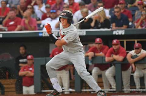 Omaha, NE – JUNE 28: Catcher Adley Rutschman #35 of the Oregon State Beavers singes in a run in the first inning against the Arkansas Razorbacks during game three of the College World Series Championship Series on June 28, 2018 at TD Ameritrade Park in Omaha, Nebraska. (Photo by Peter Aiken/Getty Images)