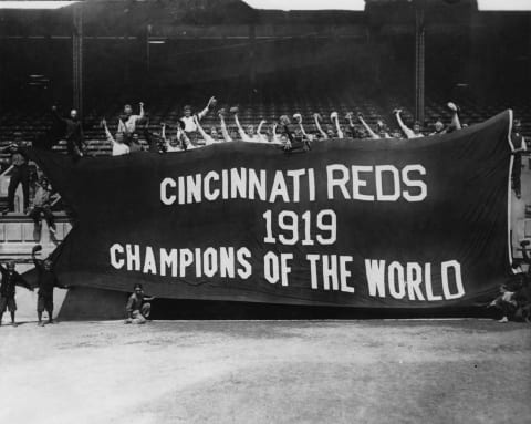 The victorious Cincinnati Reds hold up a banner after beating the Chicago White Sox in 1919’s infamous World Series. (Photo by FPG/Getty Images)