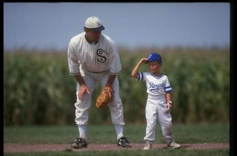 DYERSVILLE, IA – AUGUST 25: A “ghost player” recreating the role of Chicago White Sox legend Shoeless Joe Jackson plays ball with a young tourist at the baseball field created for the motion picture ‘Field of Dreams’ on August 25, 1991 in Dyersville, Iowa. Rita and Al Ameskamp who, with Don and Becky Lansing, co-own the site have turned the cornfields and baseball diamond into a summertime tourist attraction, including “ghost player” reenactments. (Photo by Jonathan Daniel/Getty Images)