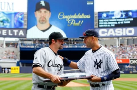 NEW YORK, NY – AUGUST 24: Derek Jeter #2 of the New York Yankees presents Paul Konerko #14 of the Chicago White Sox a team signed base in honor of Konerko’s last game at Yankee Stadium prior to the game on August 24, 2014 in the Bronx borough of New York City. Both players are retiring after the 2014 season. (Photo by Jim McIsaac/Getty Images)