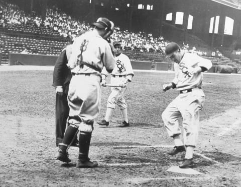 Al Simmons (R) of the Chicago White Sox touches home plate after hitting a home run. (Photo by Mark Rucker/Transcendental Graphics, Getty Images)